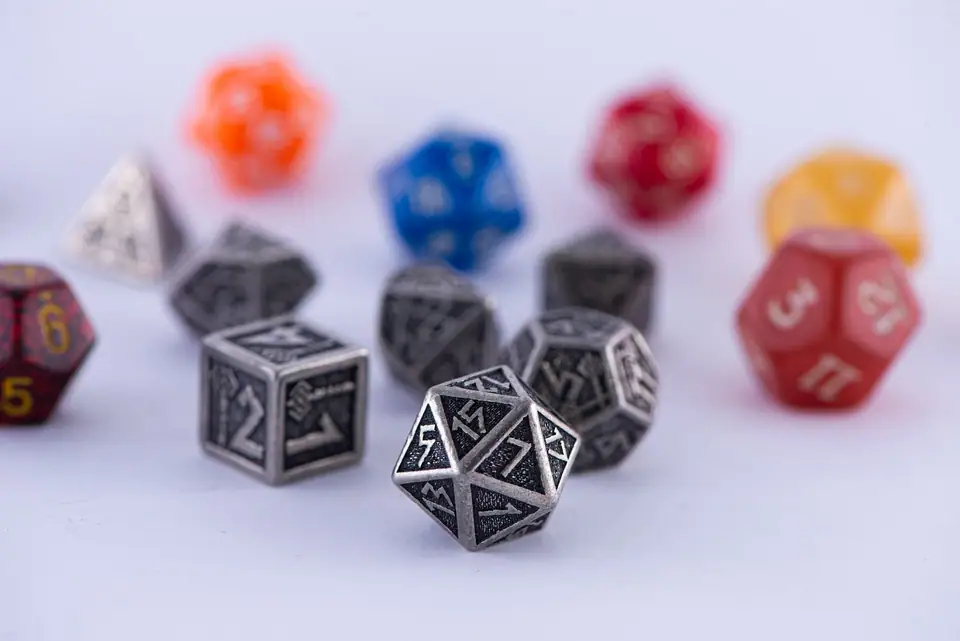 Colorful gaming dice arranged on a white surface, showcasing variety for board games and role-playing.