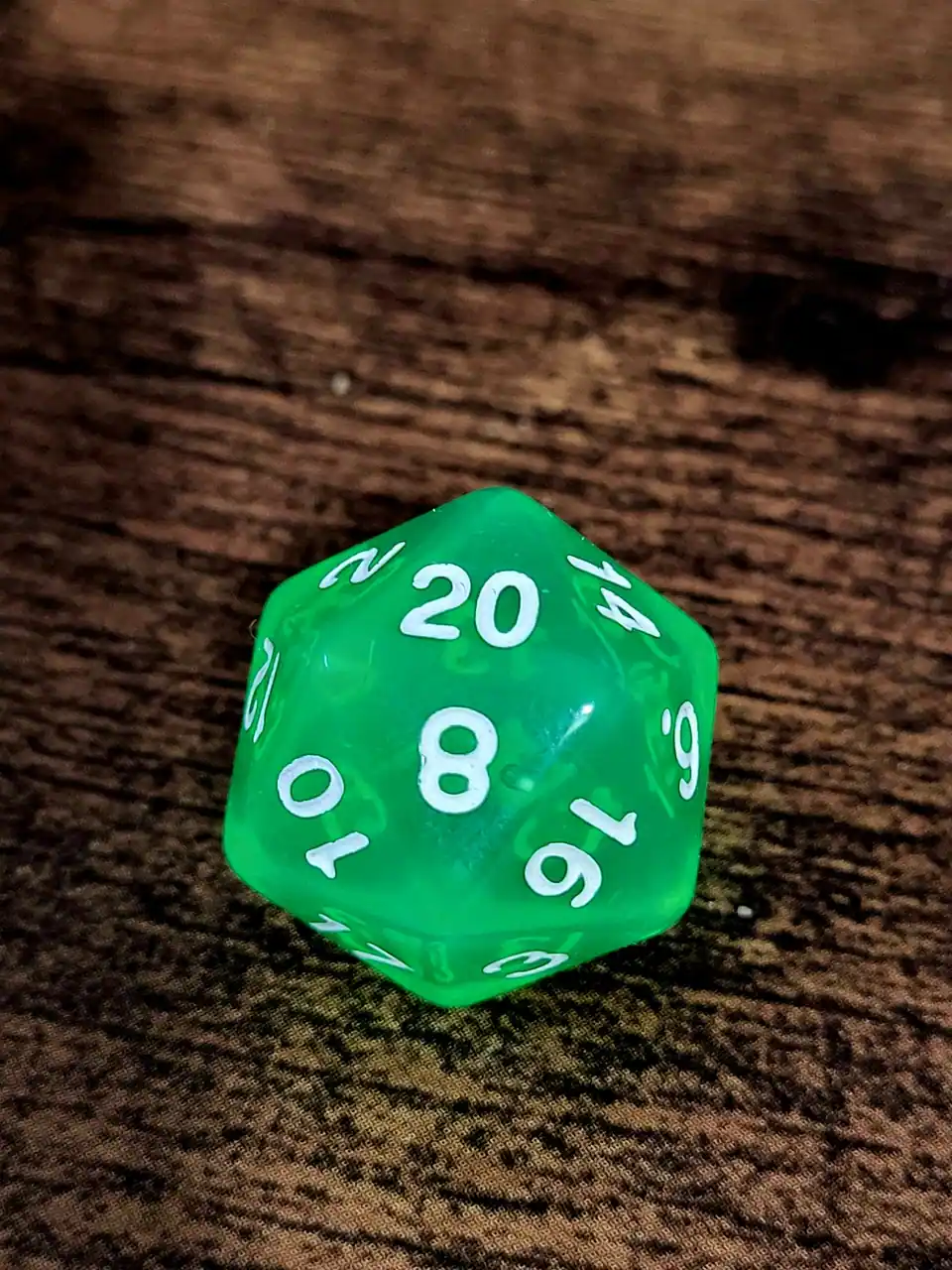 A bright green twenty-sided die (d20)